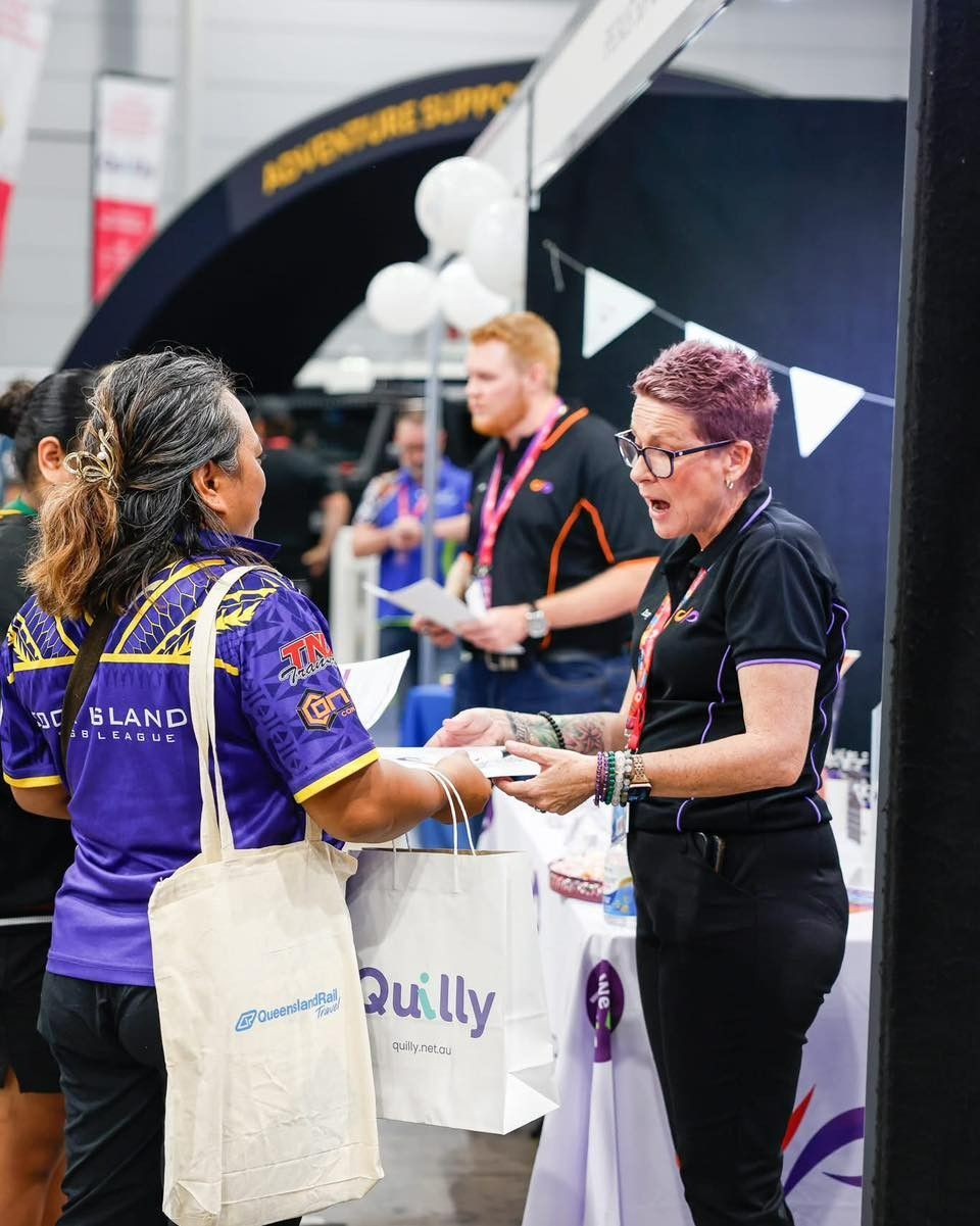 A Woman in a Purple Shirt is Talking to Another Woman — Specialist Support Solutions in Rockhampton City, QLD