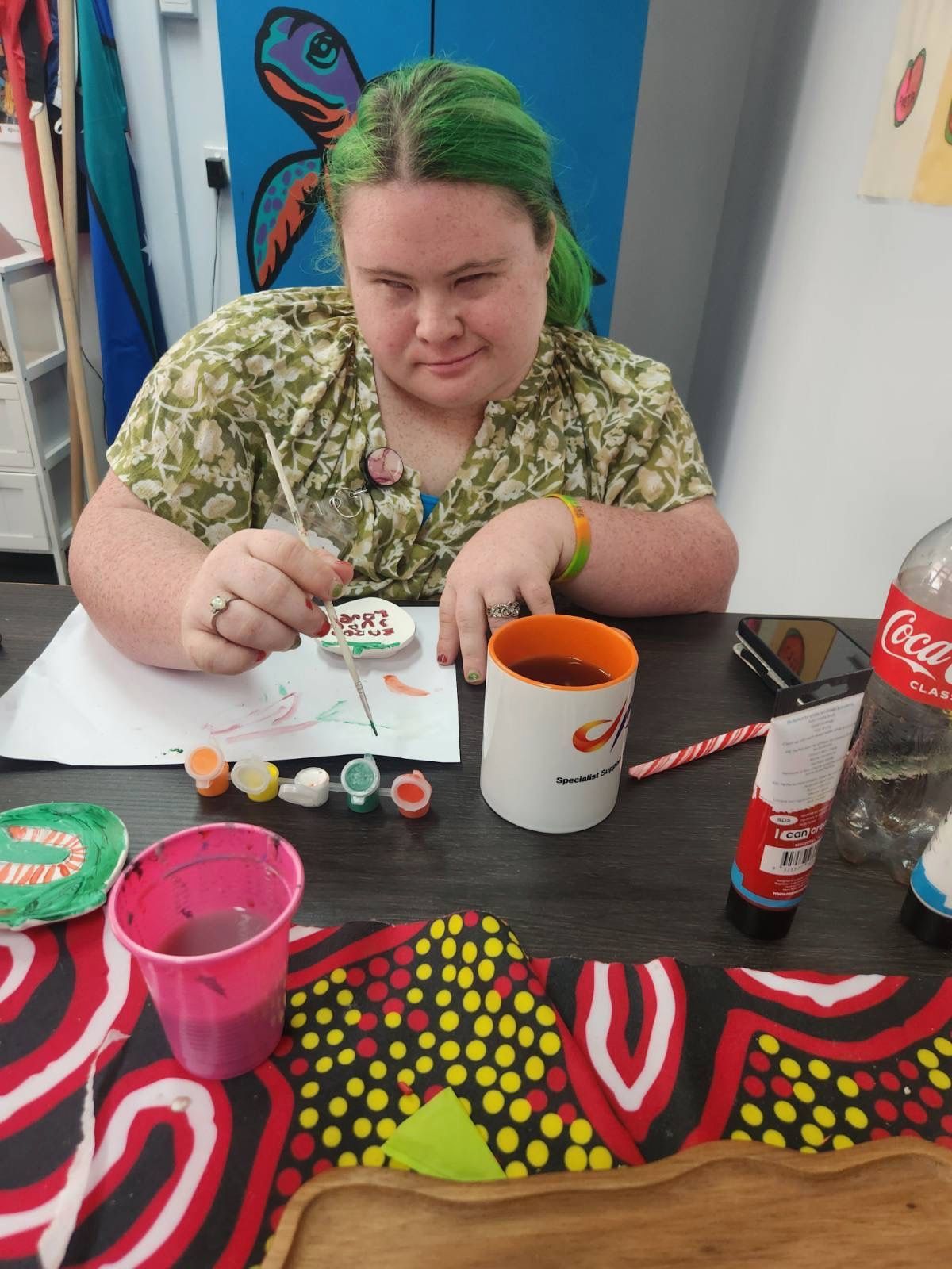A Woman is Helping Another Woman With Her Homework — Specialist Support Solutions in Gladstone, QLD