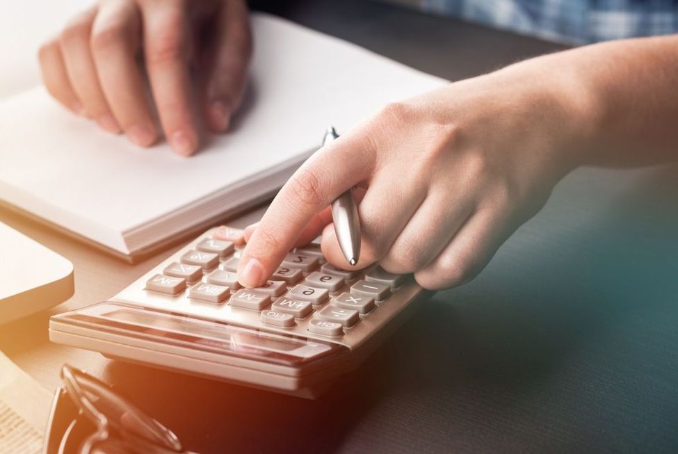 Accountant Using Calculator — Bosco Accounting Pty Ltd In Warrawong, NSW