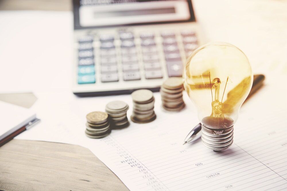 Lightbulb Aside Coins and Calculator — Bosco Accounting Pty Ltd In Warrawong, NSW