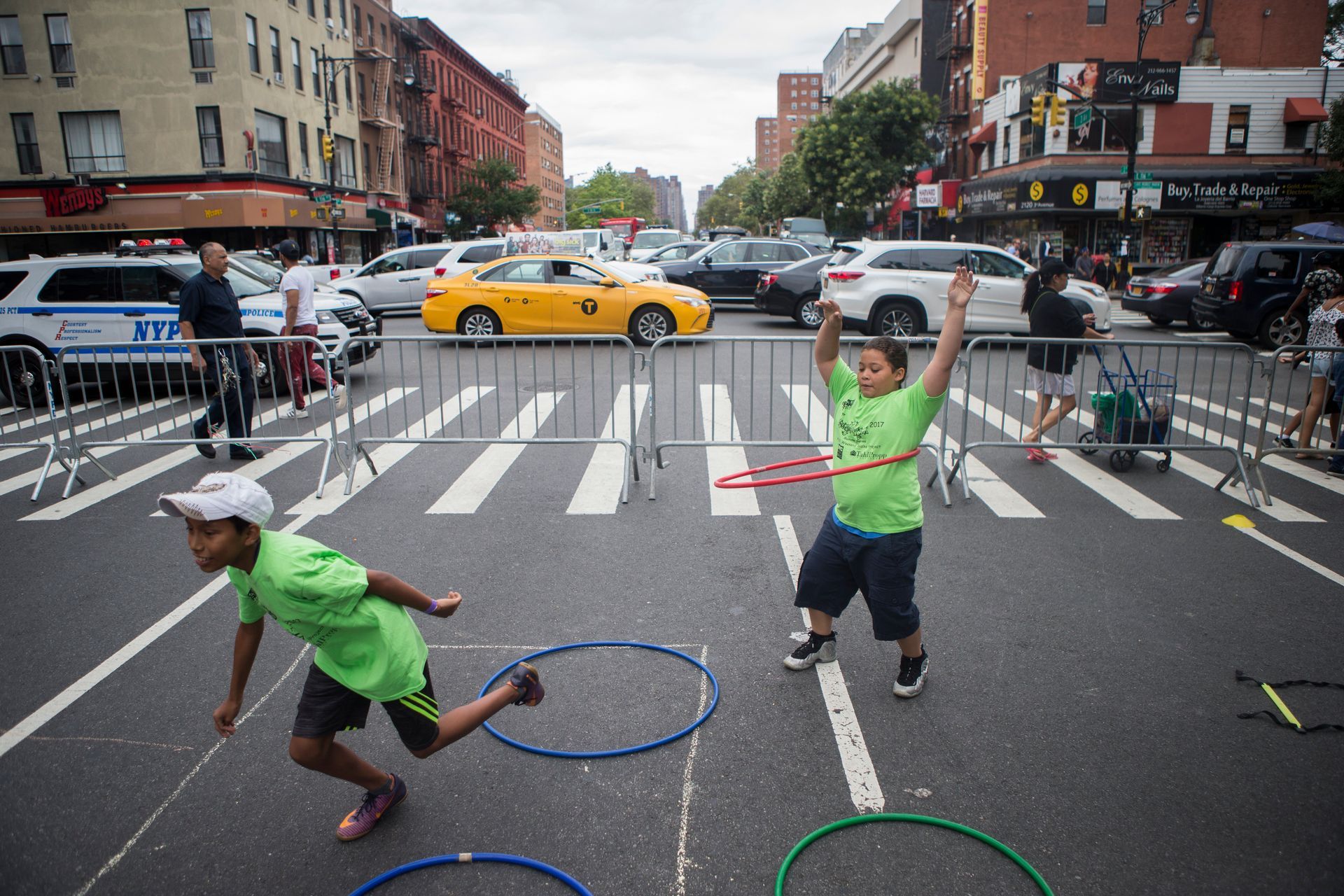 Children hula hoop and race on the streets of Harlem during Concrete Safari's 5th Annual Obstacle race and Active living fair in Harlem on August 29, 2017.