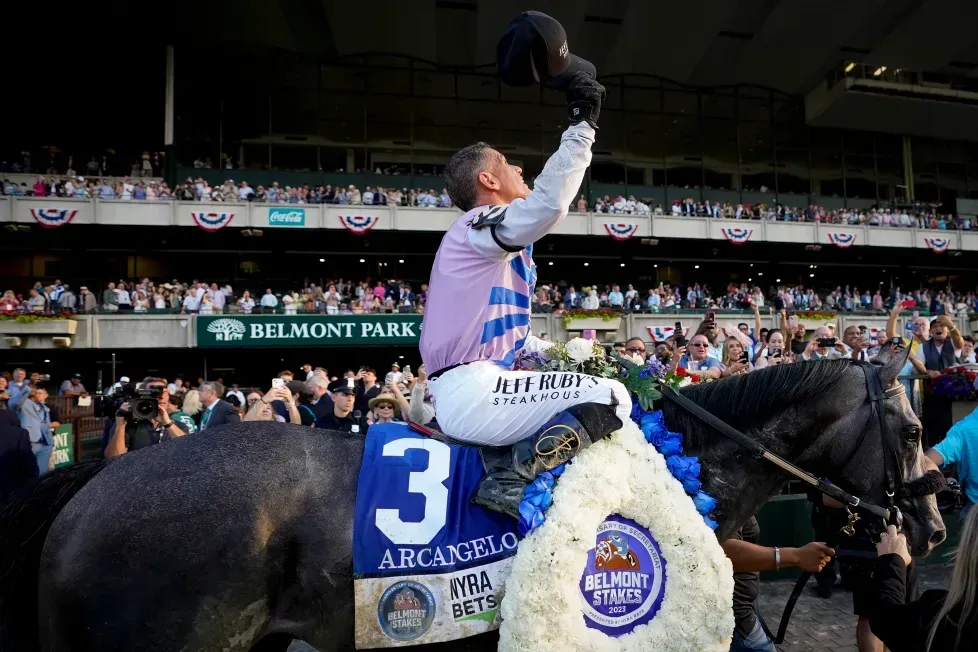 A jockey is riding a horse with the number 3 on it.
