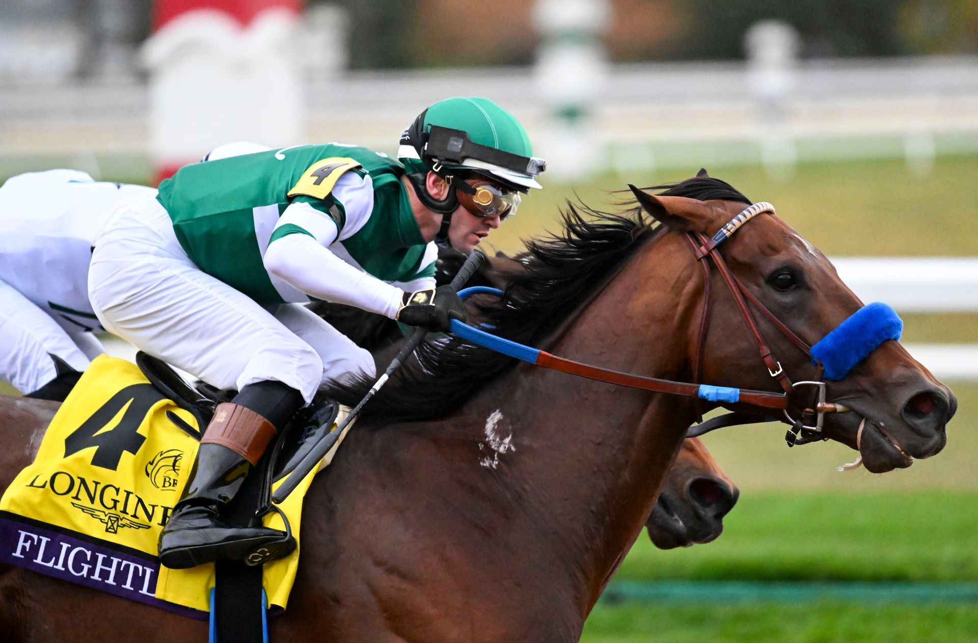 HBA Media | a jockey is riding a horse in a race .