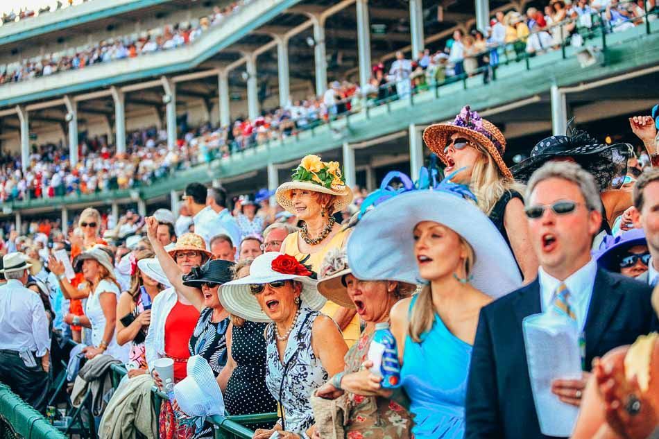 A crowd of people wearing hats are standing in a stadium.