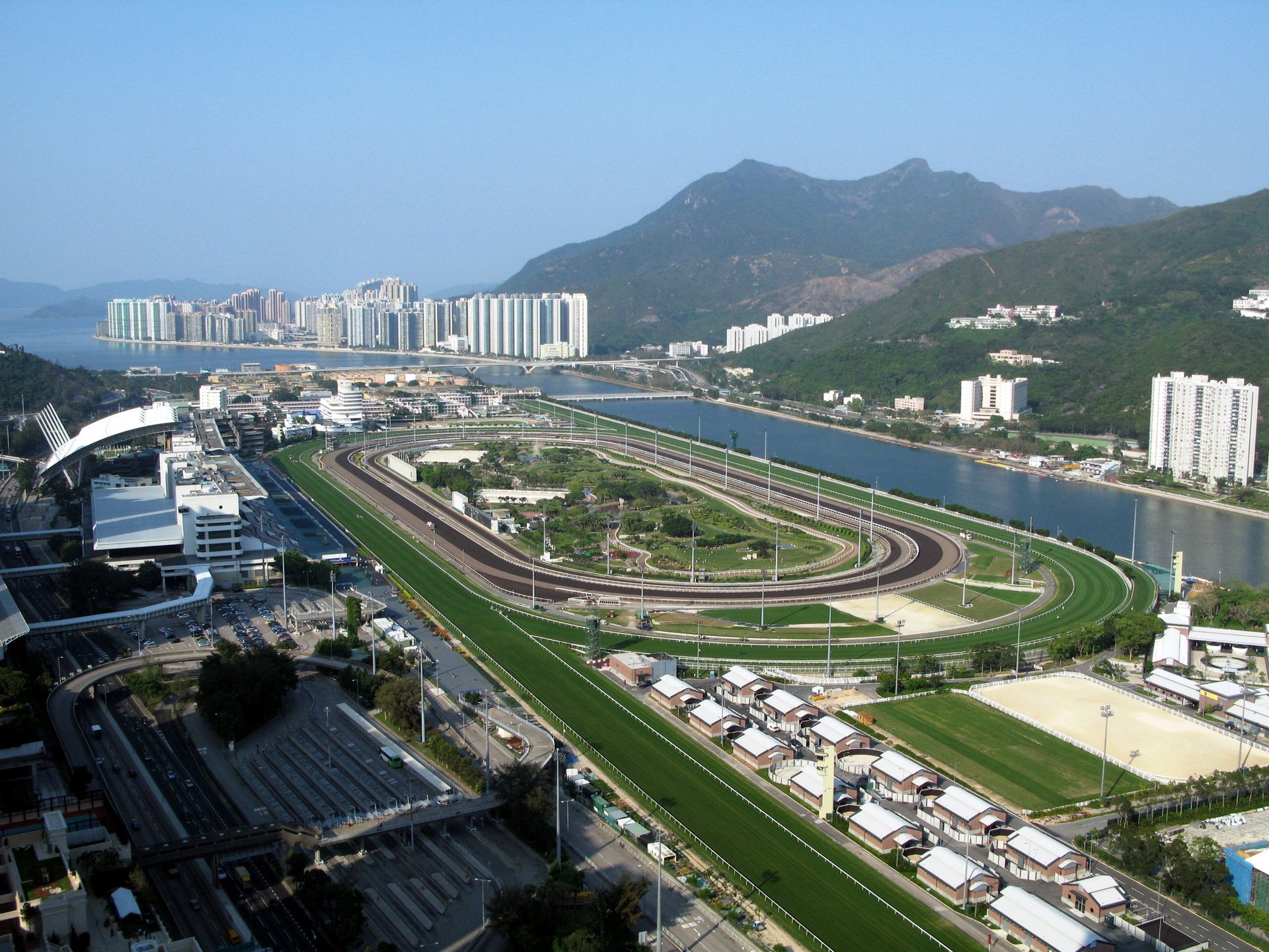 An aerial view of a race track with mountains in the background