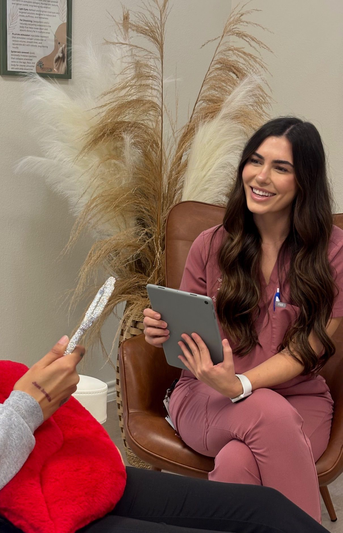 Woman getting a cosmetic procedure. Blonde woman smiles as professional marks her face with a pen.