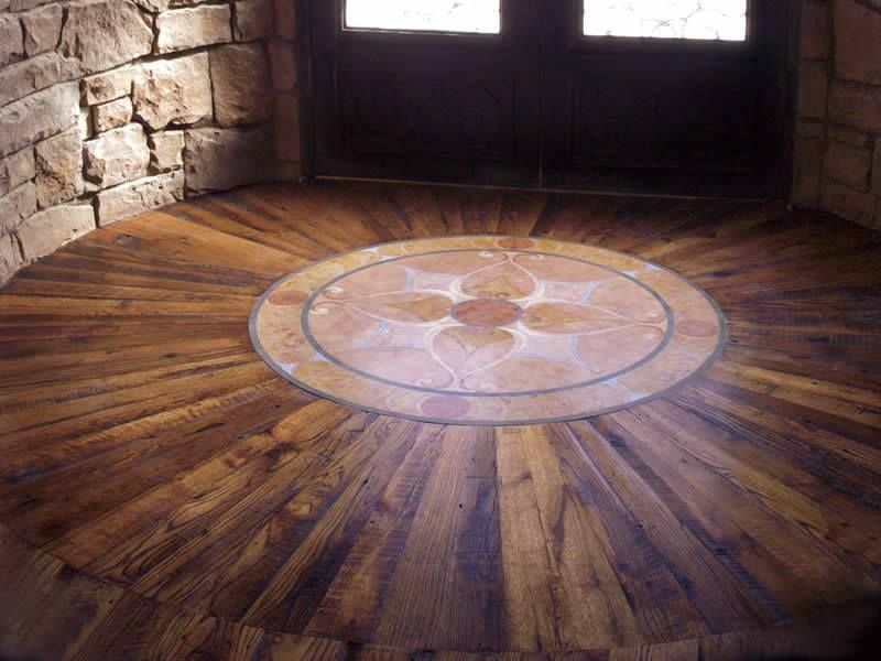A wooden floor with a circular design in the middle