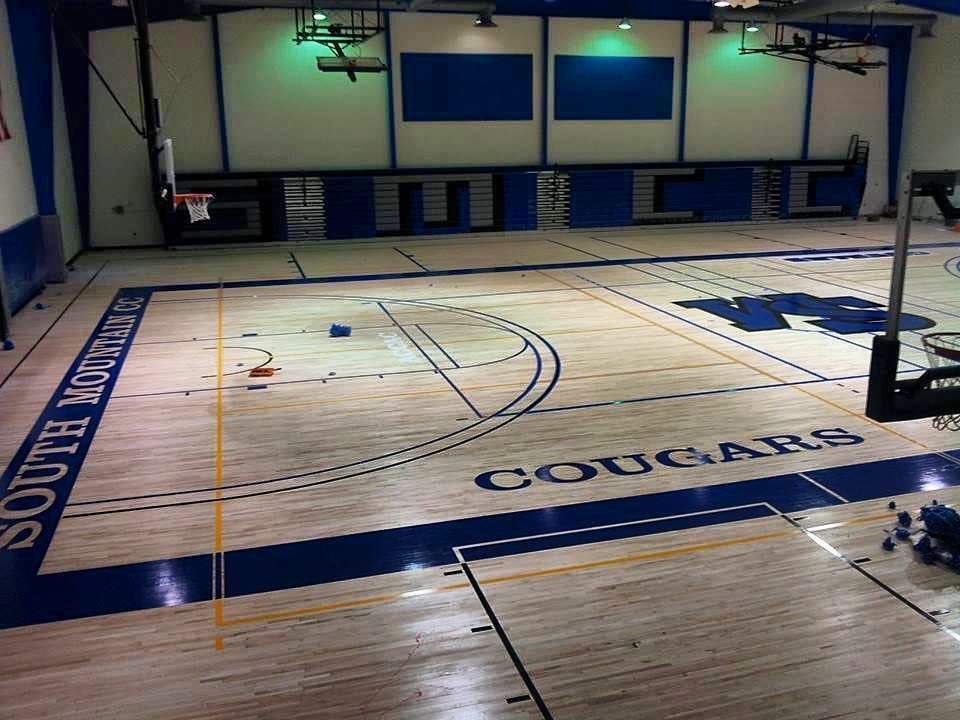 A basketball court with the word cougars on it