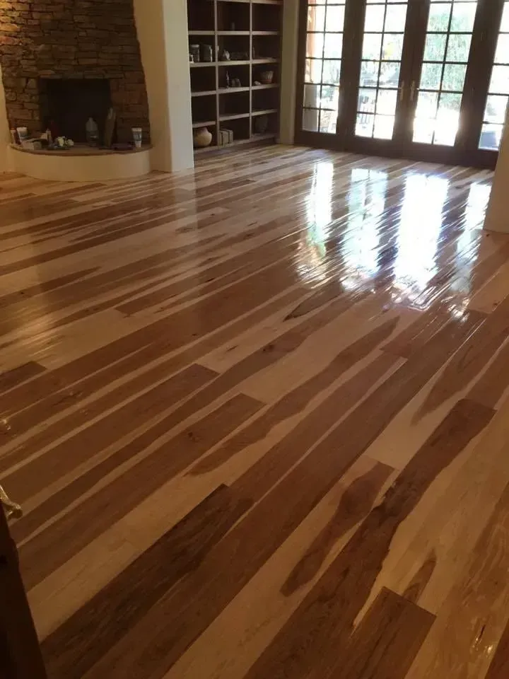 A living room with hardwood floors and a fireplace