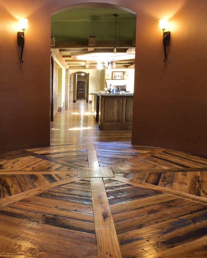 A wooden floor with a geometric pattern in a hallway