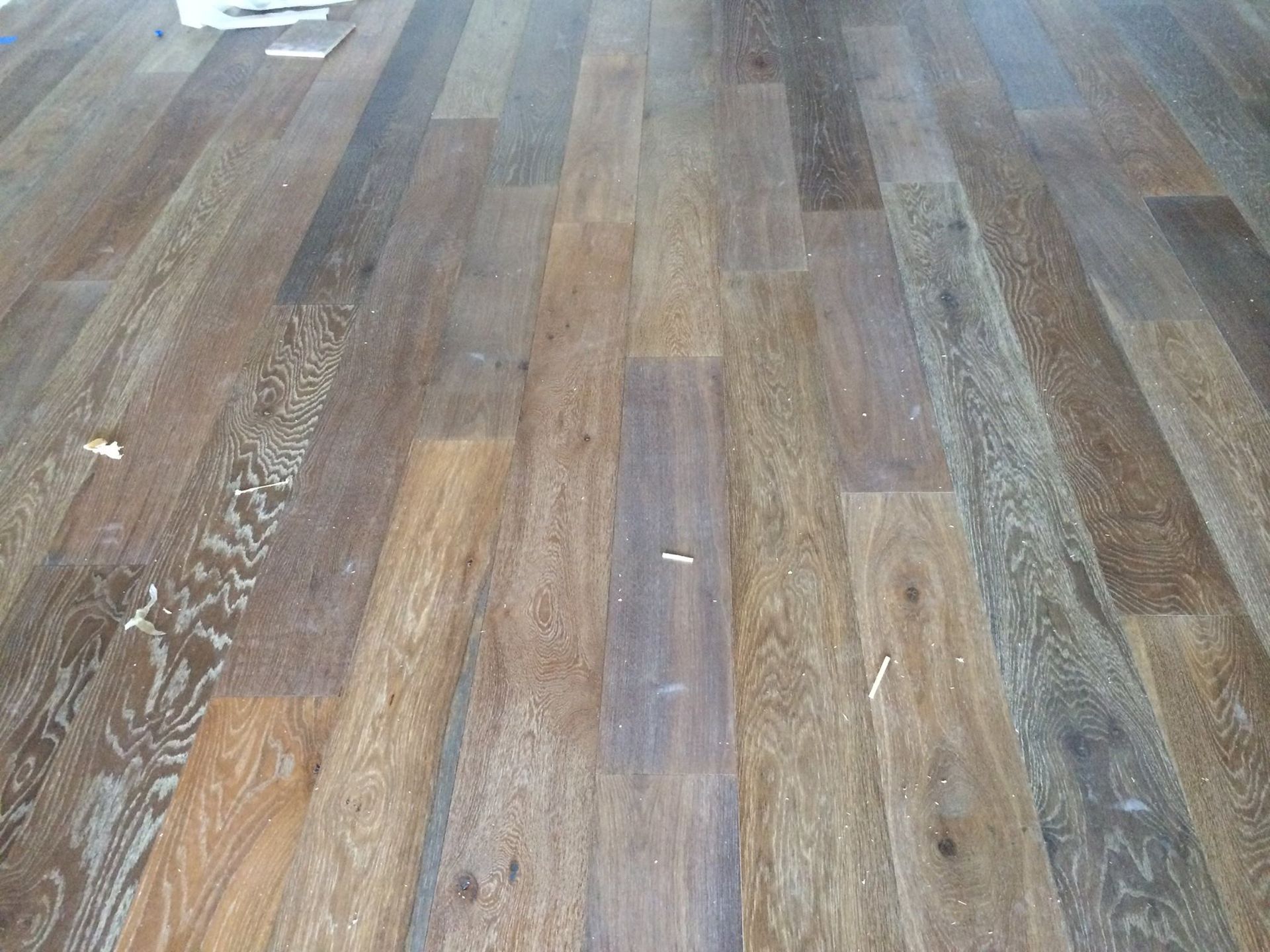 Wood floor with varying shades of brown planks.
