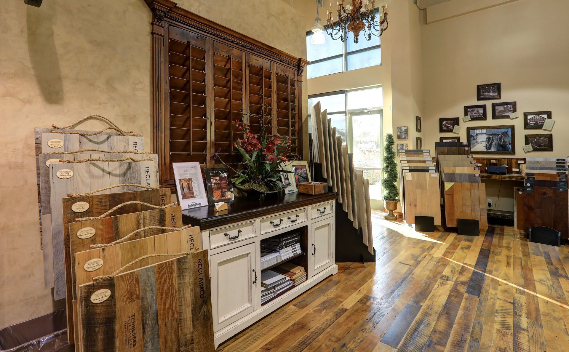 A room with hardwood floors and a display of wooden flooring in a store.