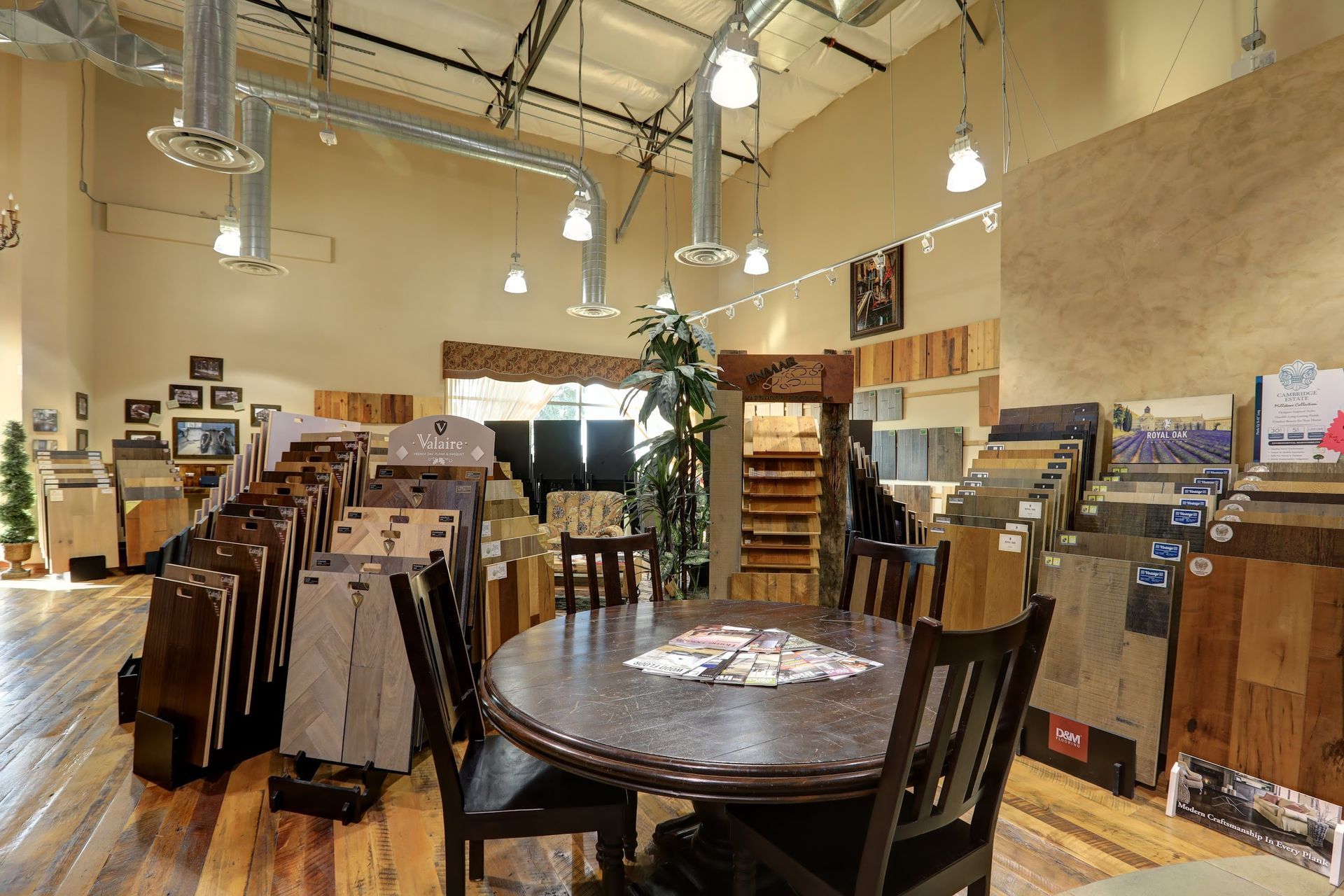 There is a table and chairs in the middle of the room.