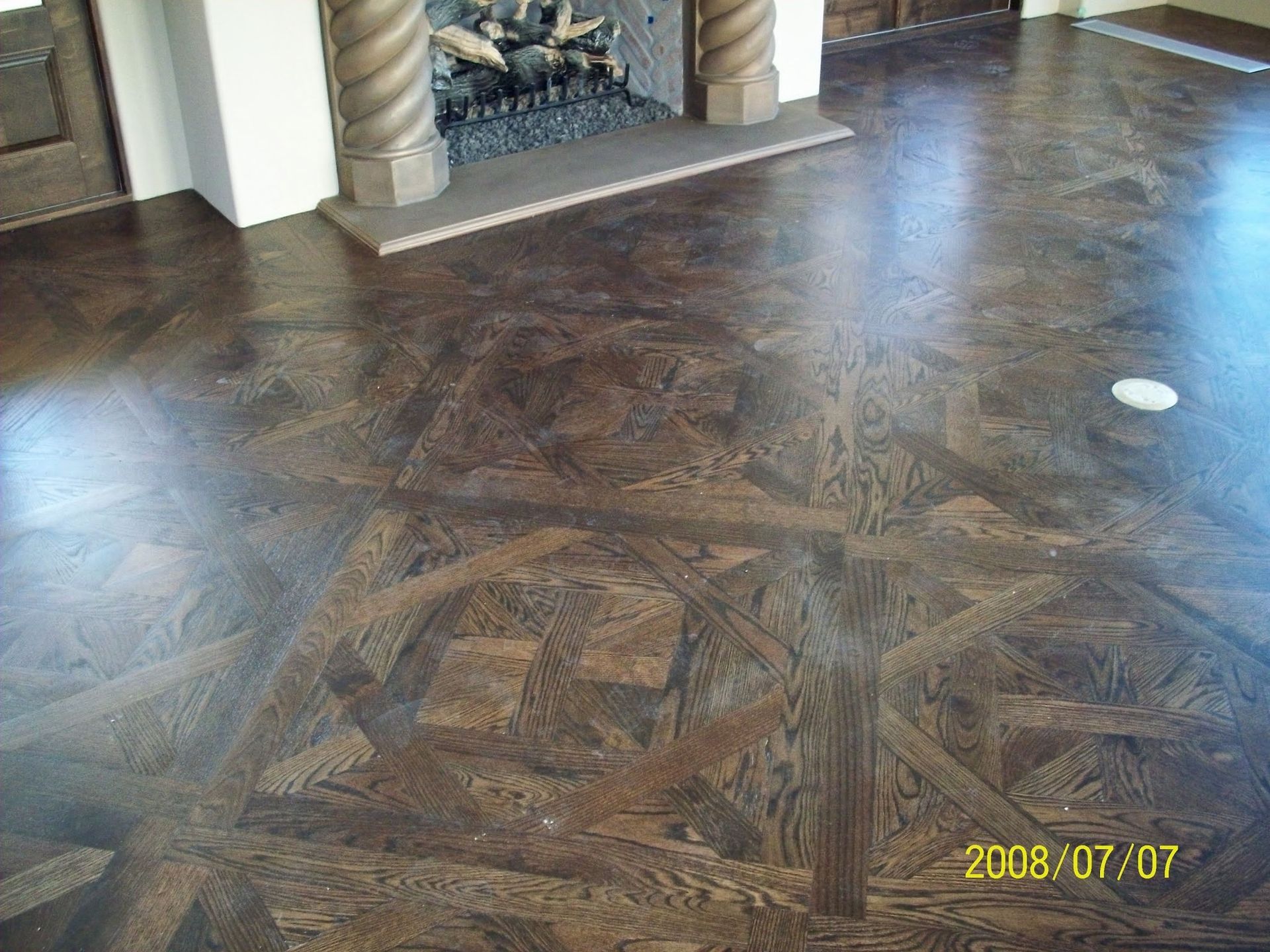 A living room with a fireplace and a wooden floor