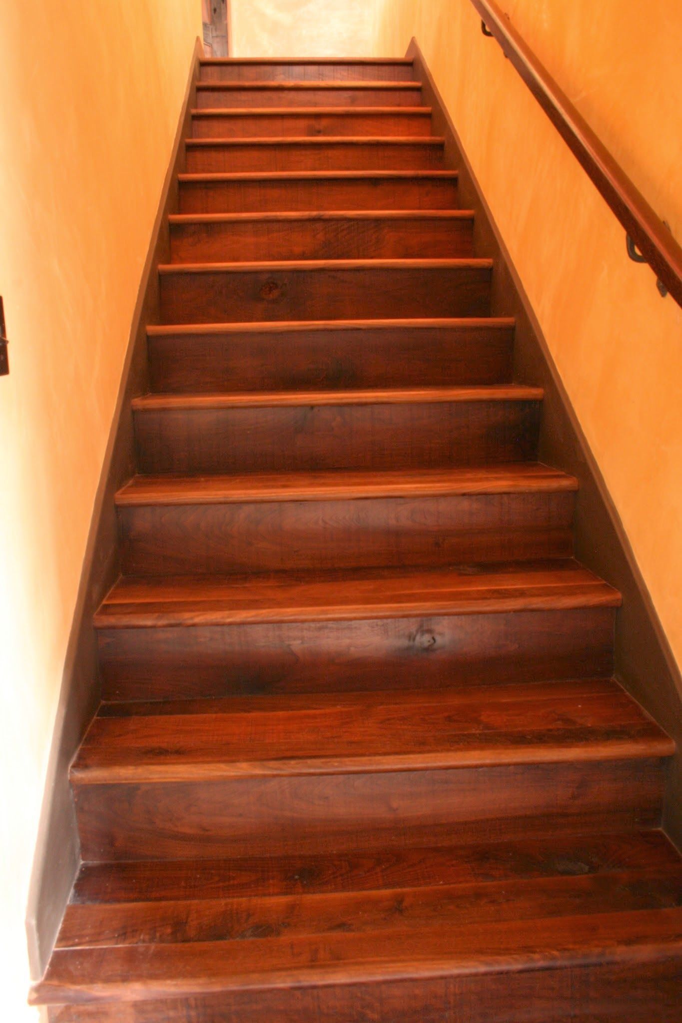 A set of wooden stairs leading up to the second floor