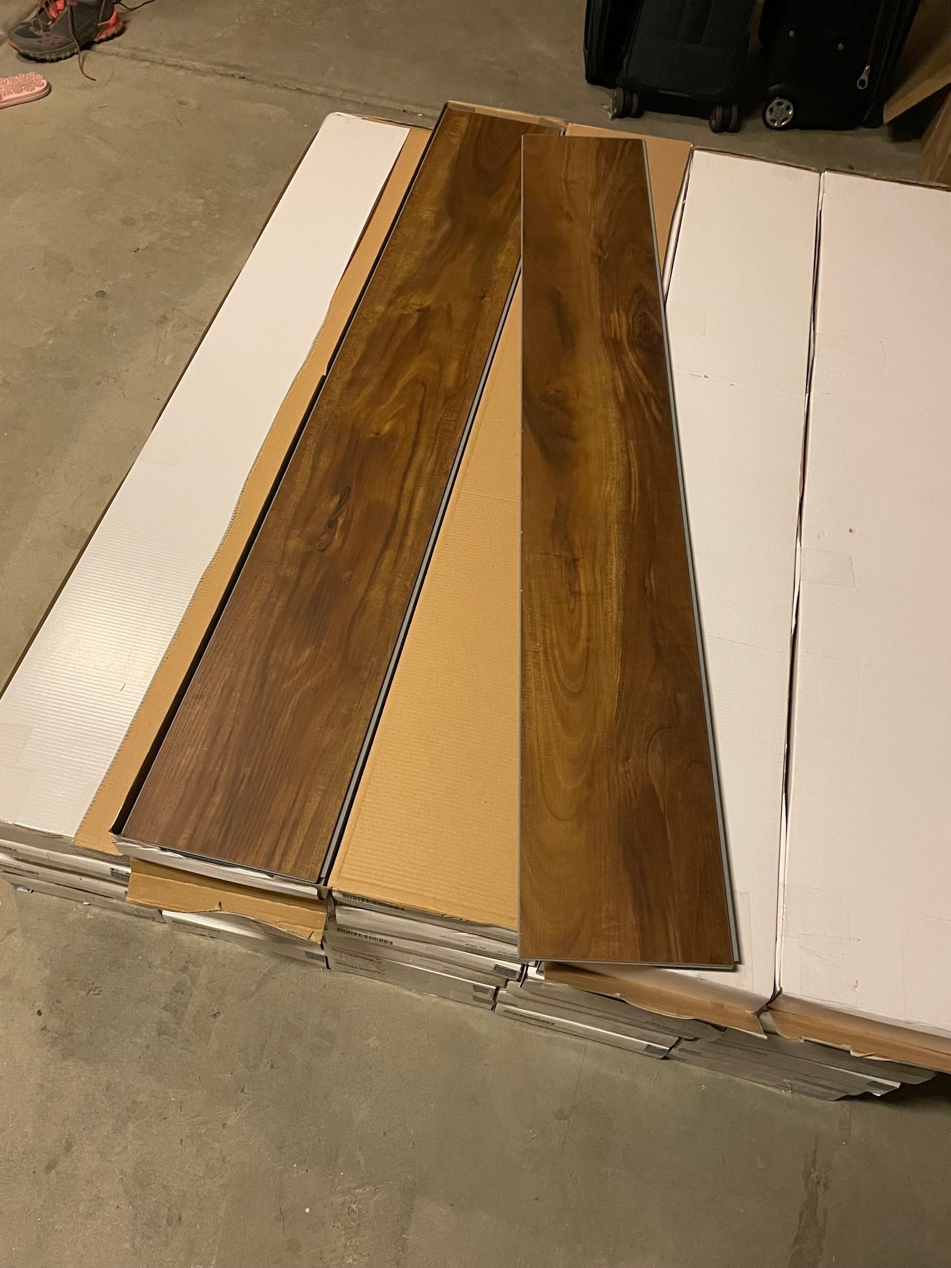 A bunch of wooden boards are sitting on top of each other on the floor.