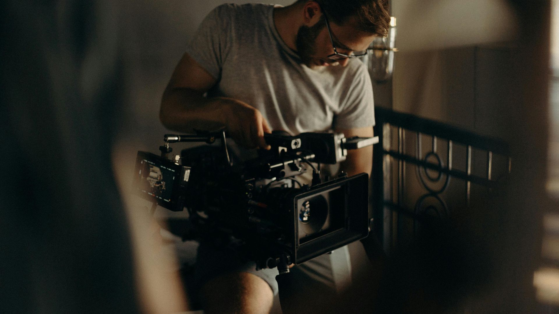 A Brite Point Media filmmaker meticulously preparing a cinema camera, showing a passion for the craft of filmmaking.