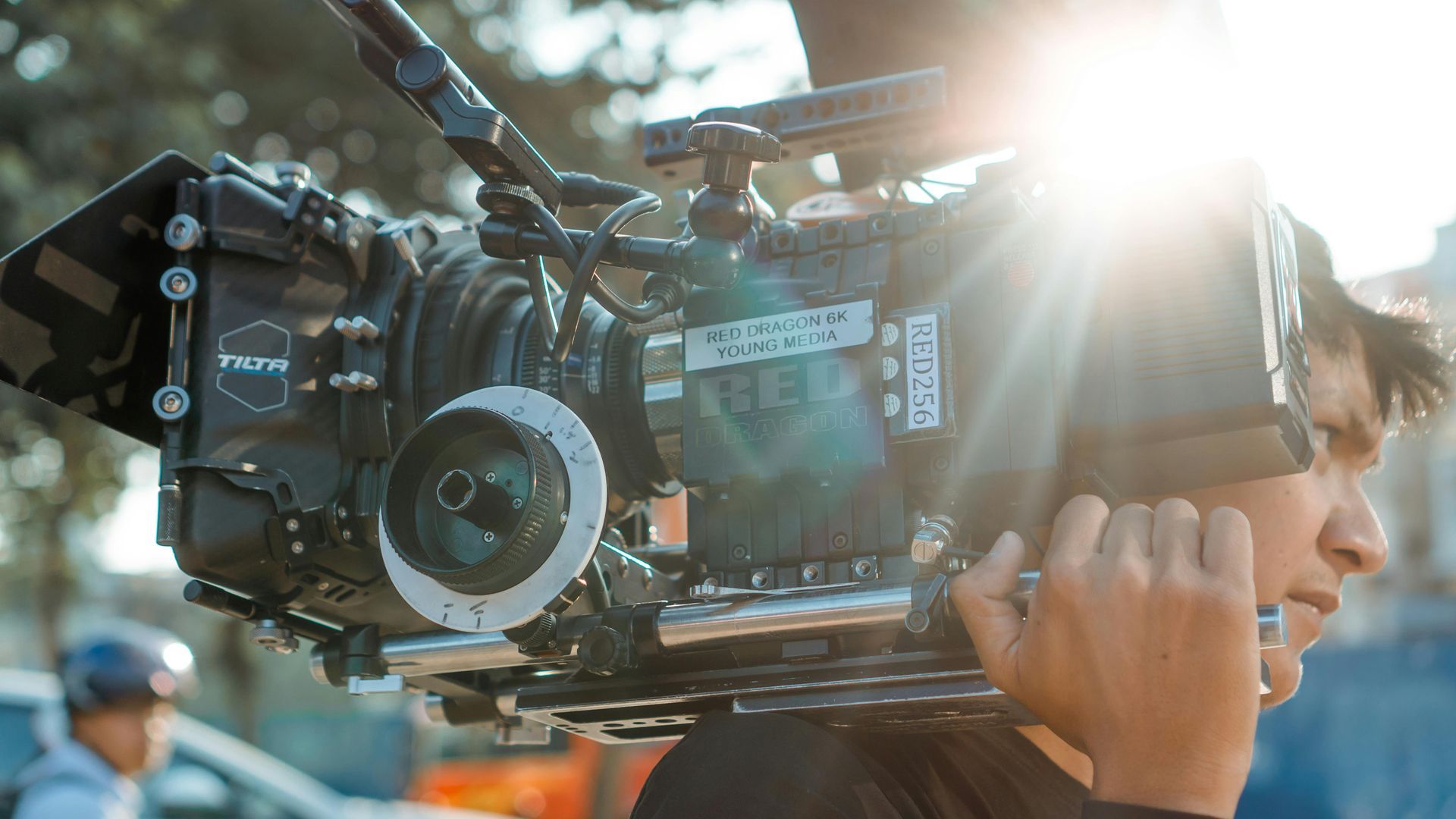 A professional cinematographer filming on location for a Brite Point Media video production project.