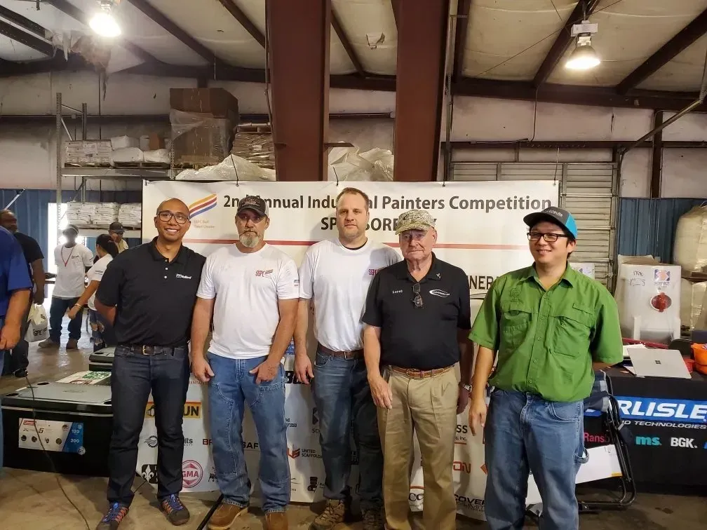 A group of men are posing for a picture in a building.