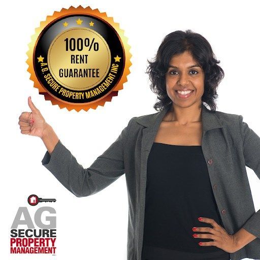 Smiling woman in a blazer giving a thumbs-up next to a 100% rent guarantee badge for AG Secure Property Management.