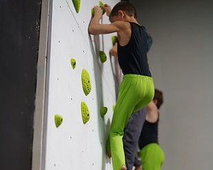 A group of children are sitting at a table playing with toys.