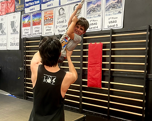 A group of children are celebrating a birthday with a cake and presents
