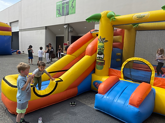 A group of children are standing next to each other and smiling.
