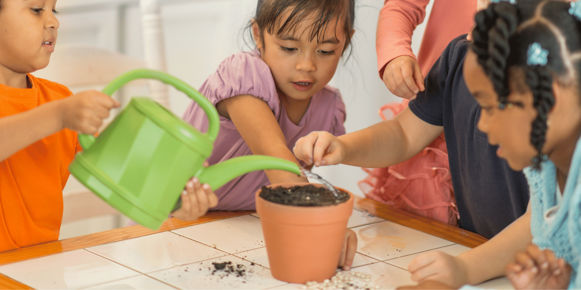 A teacher is giving a high five to a group of children in a classroom.
