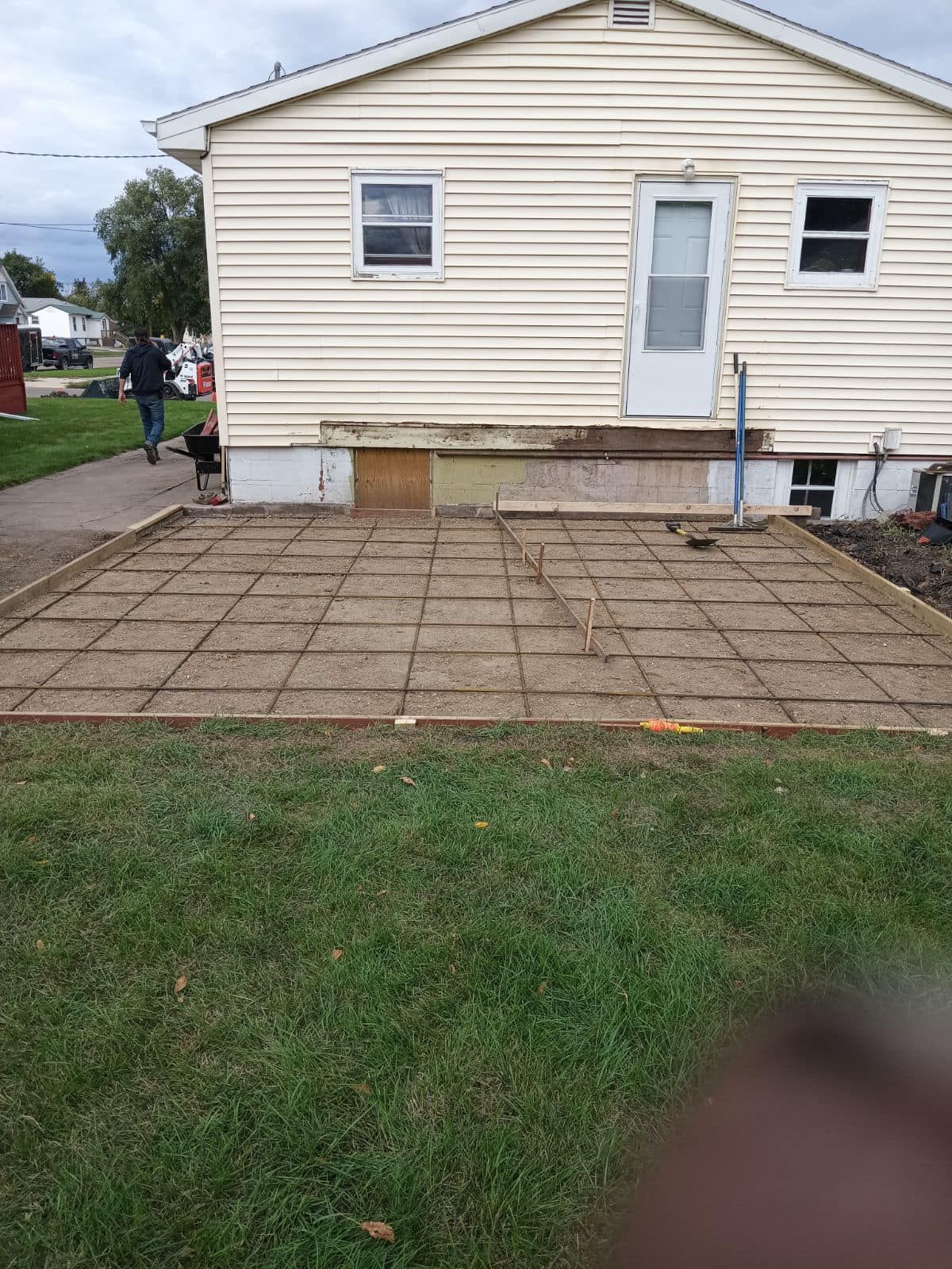 A house with a concrete patio in front of it.