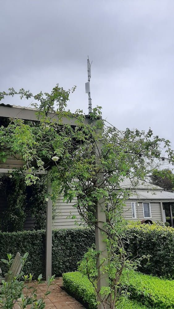 A House With A Pergola And A Tree In Front Of It — Boardman's TV Antennas in Basin View, NSW