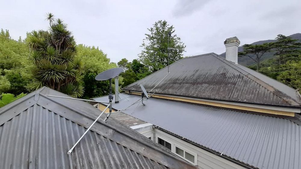 A Roof Of A House With A Satellite Dish On It — Boardman's TV Antennas in Basin View, NSW