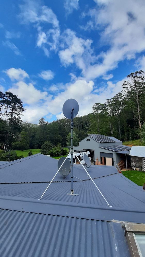 A Satellite Dish And The Roof Of A House — Boardman's TV Antennas in Basin View, NSW
