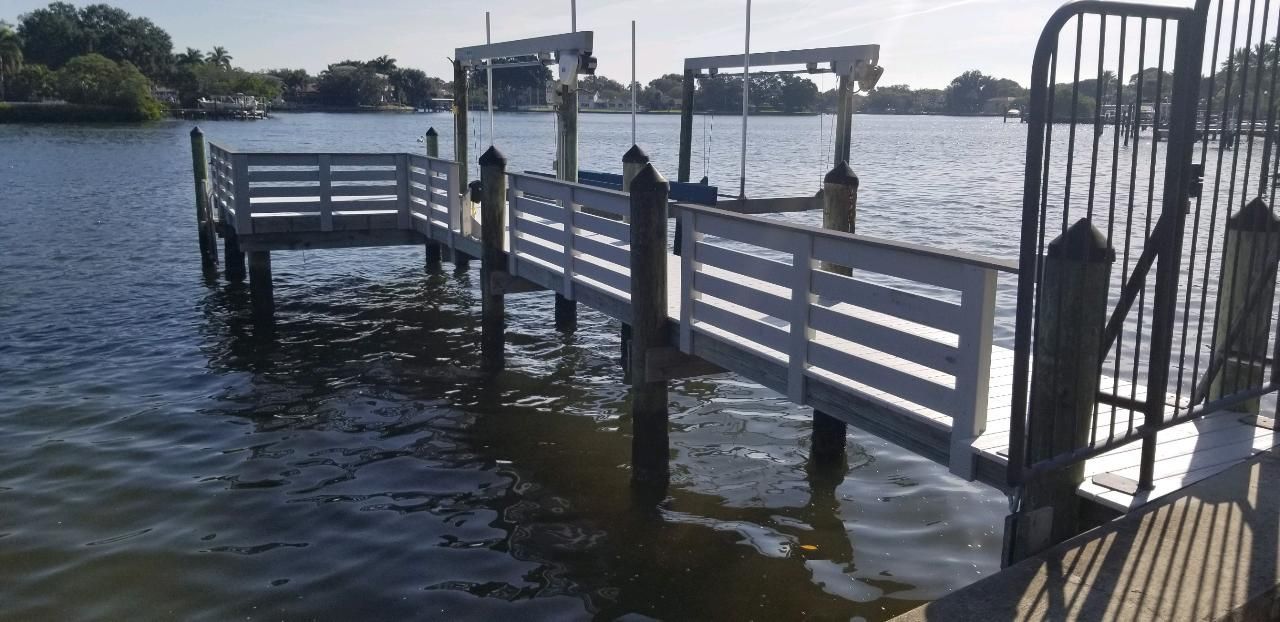 A dock is sitting in the middle of a large body of water.