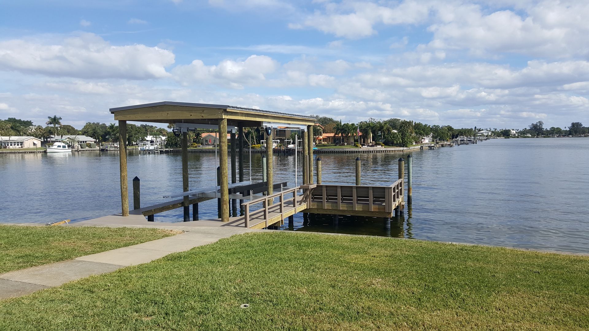 There is a dock in the middle of the water.