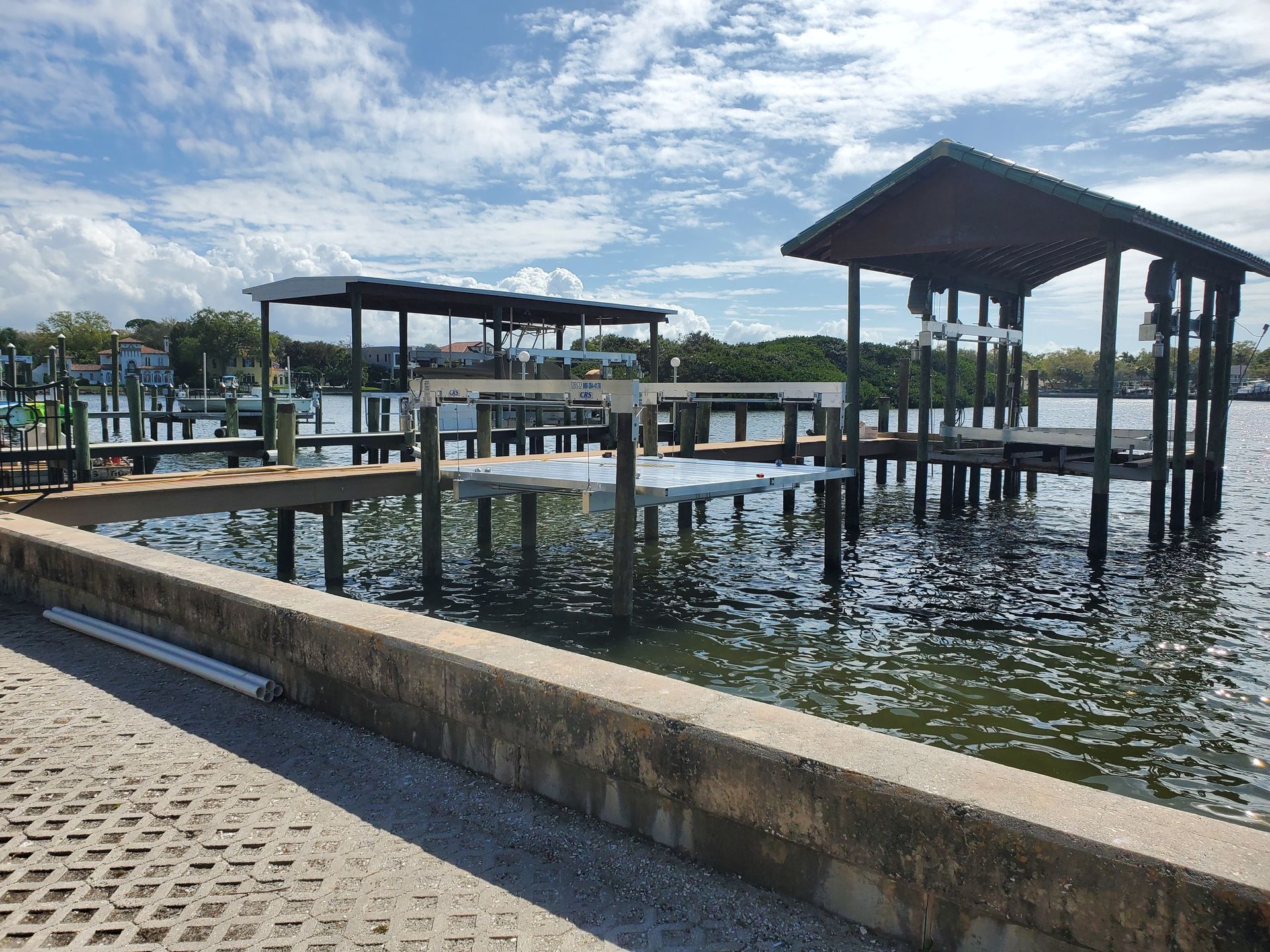 A dock with a shelter on top of it in the middle of a body of water.