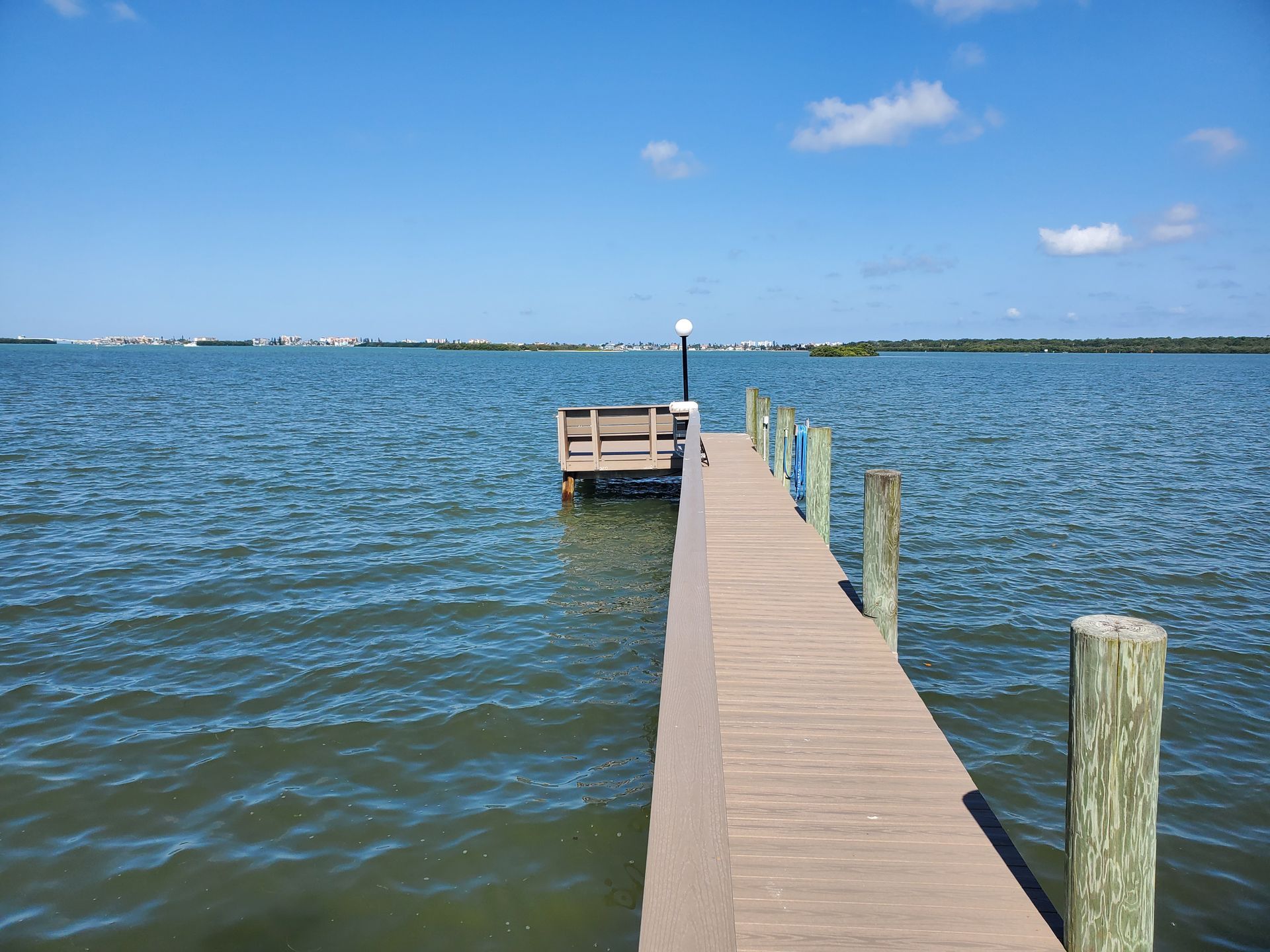 A wooden dock leading into a large body of water.