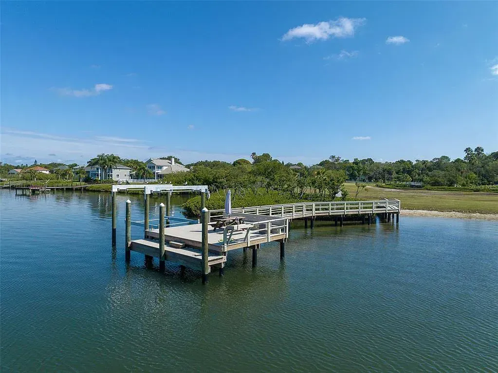 An aerial view of a dock in the middle of a body of water.
