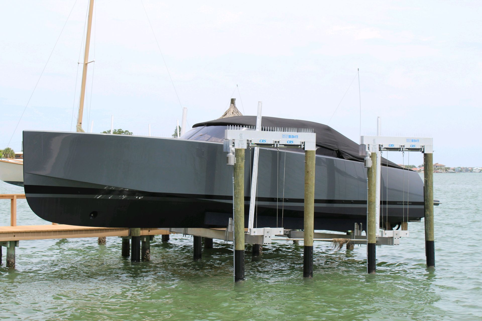 A boat is sitting on a lift in the water
