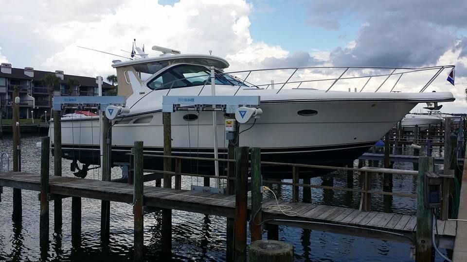 A large white boat is docked at a dock.