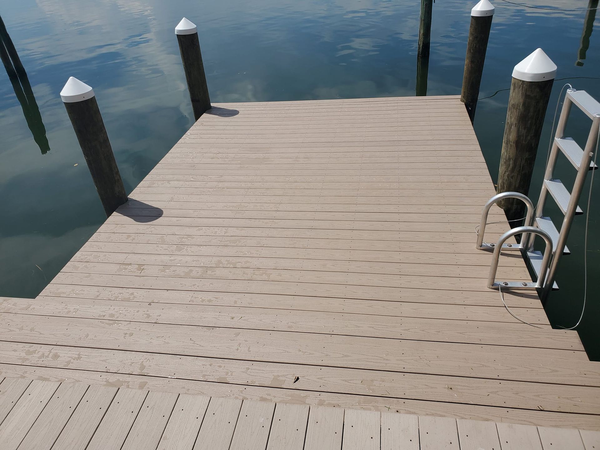 A dock with a ladder leading to the water