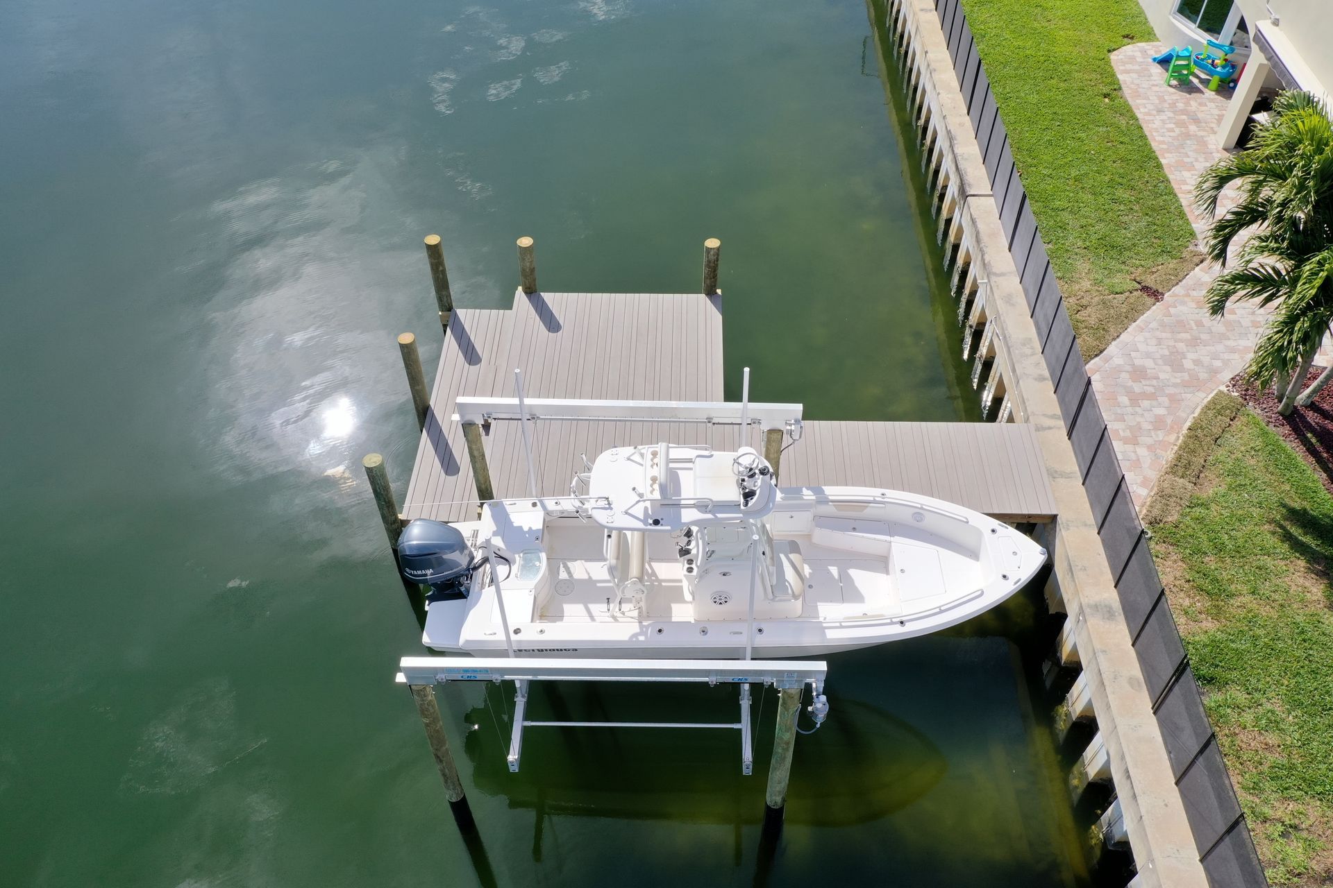An aerial view of a boat docked at a dock in the water.