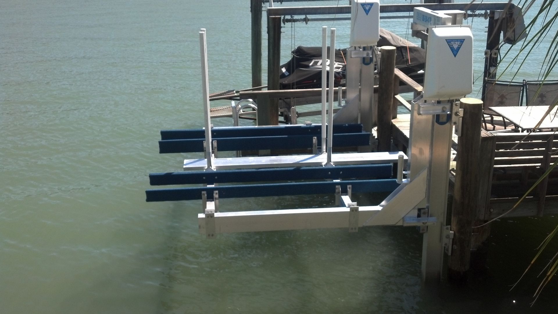 A boat lift with a dock attached to it.