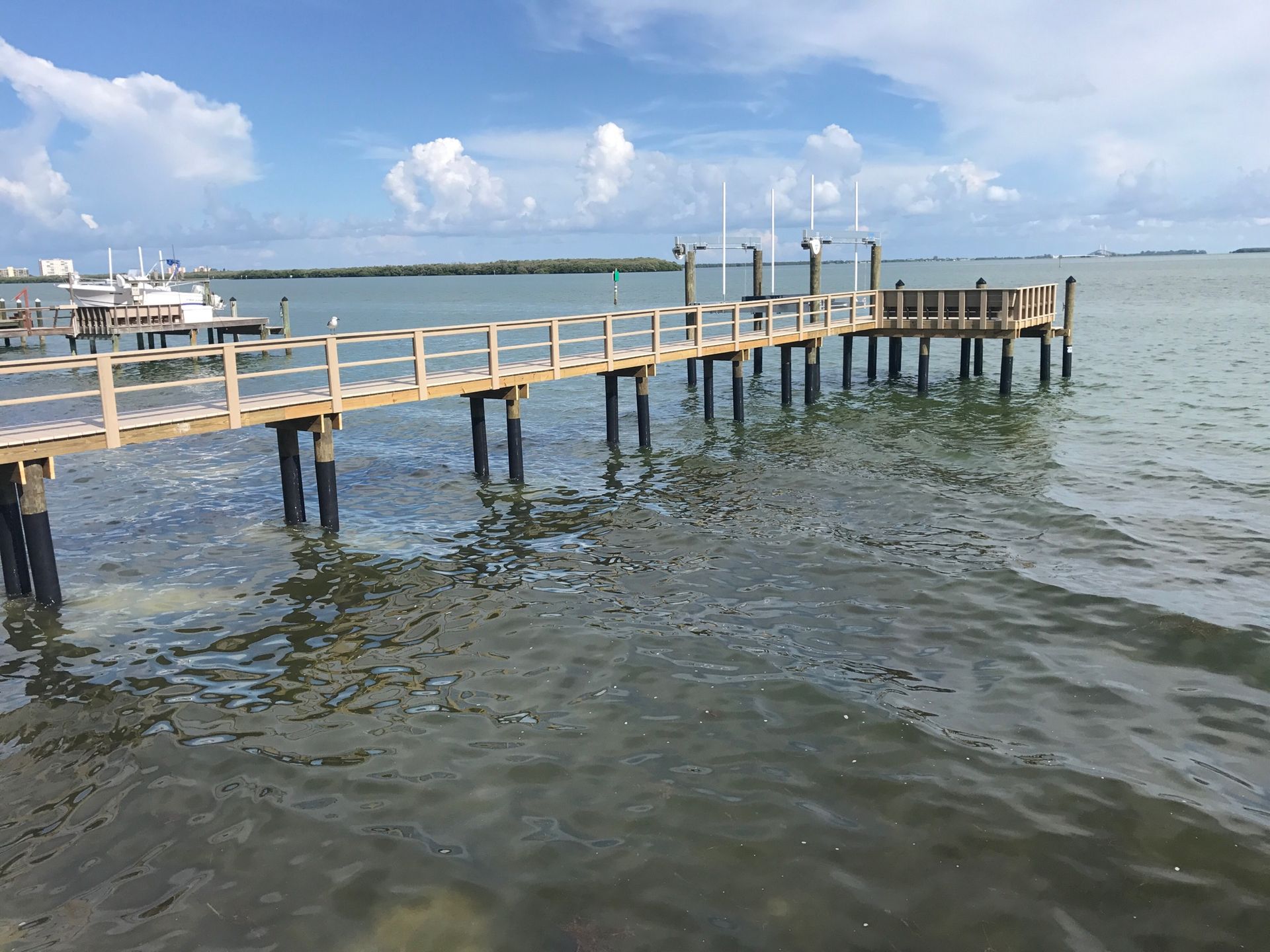 A wooden dock is in the middle of a body of water.