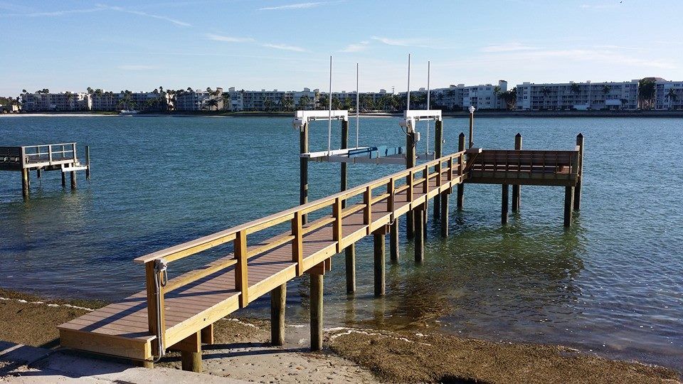 A wooden dock in the middle of a body of water.