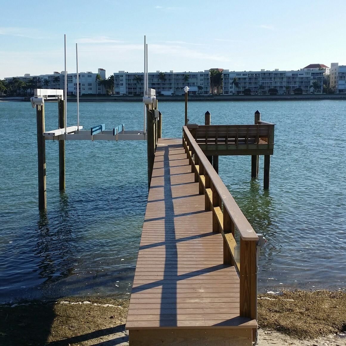 A wooden dock leading to a body of water.