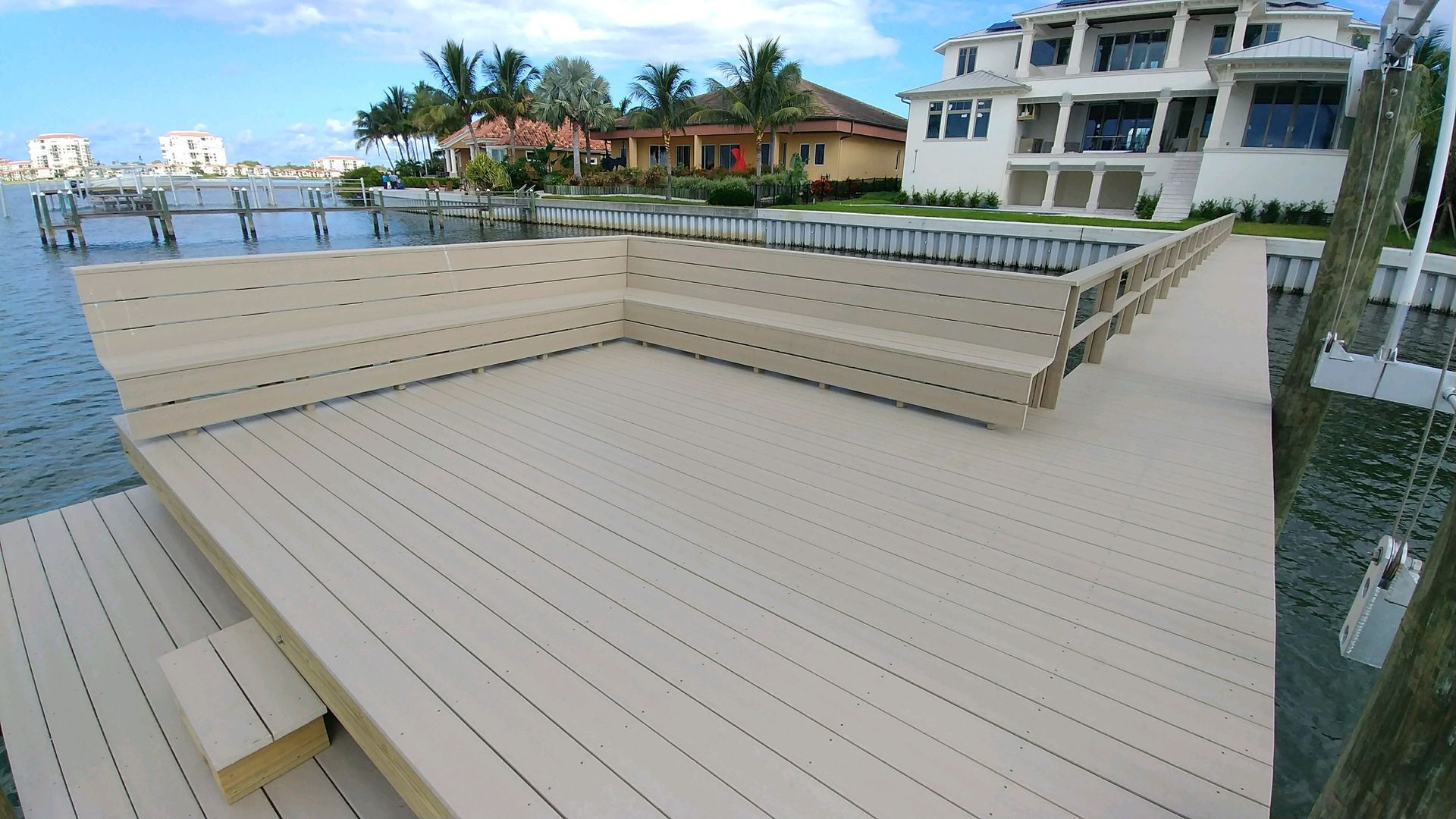 A dock with a large house in the background