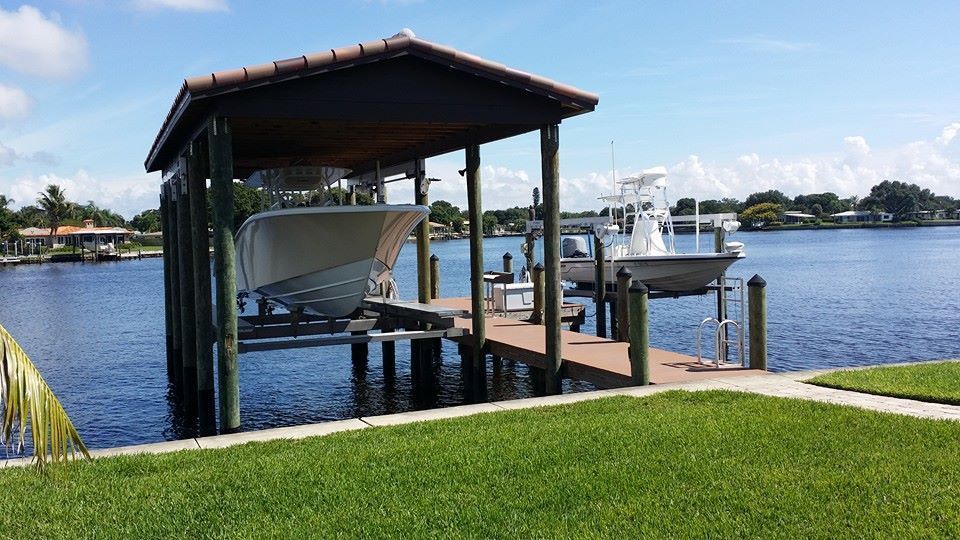 A boat is docked at a dock next to a body of water.