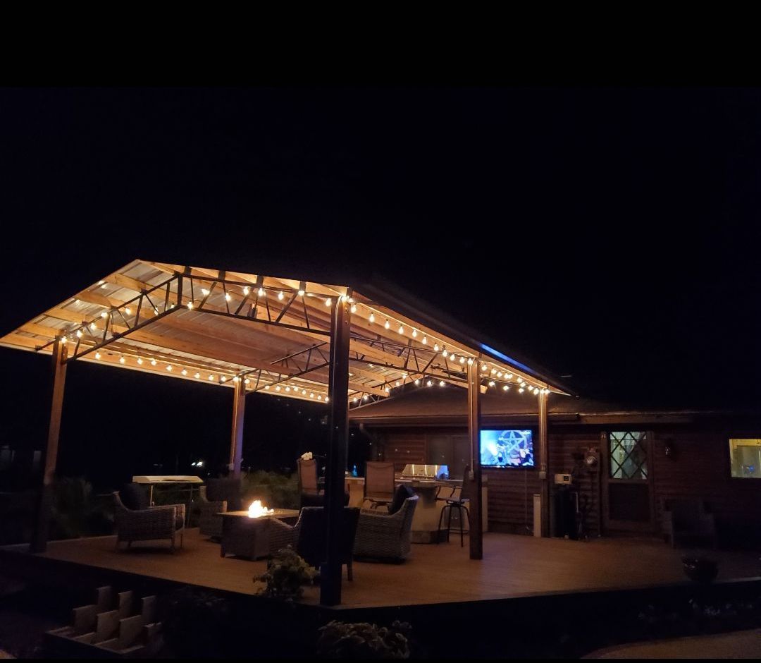 A gazebo with lights on it is lit up at night