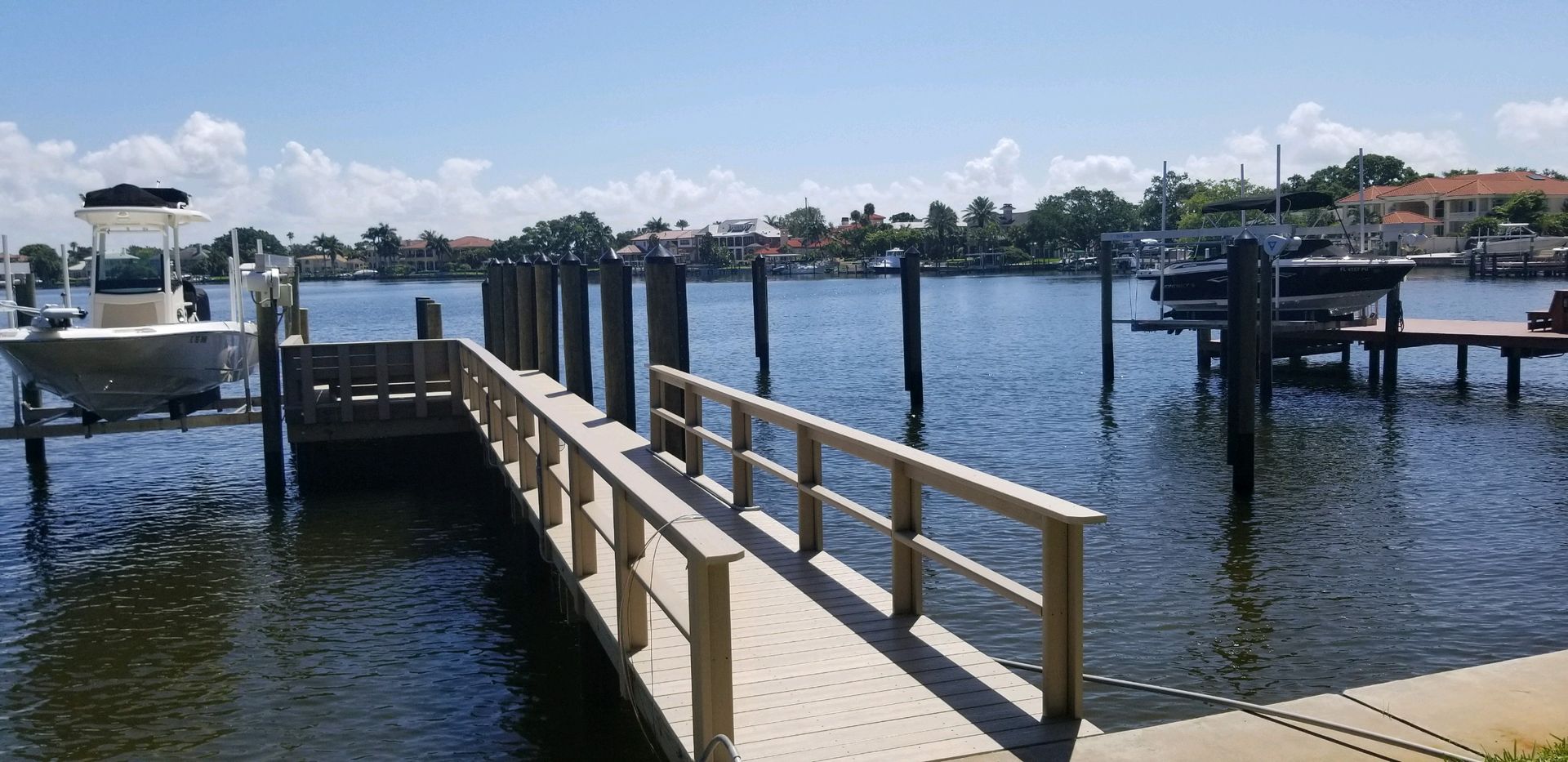 A boat is docked at a dock next to a body of water.