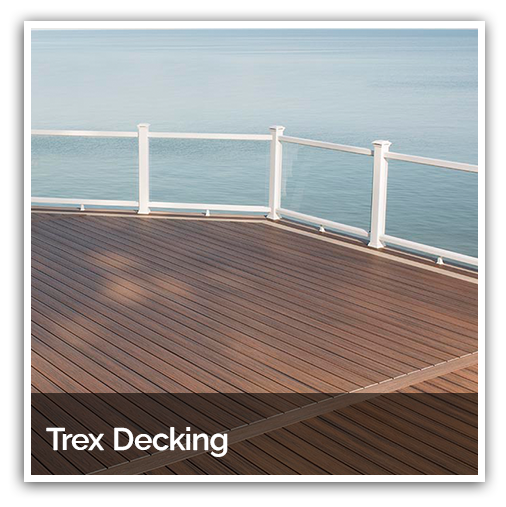 A picture of a commercial Trex deck with a white railing overlooking the ocean.